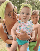 Mom and little girl are wearing matching mommy and me headbands from By Bella Boutique.